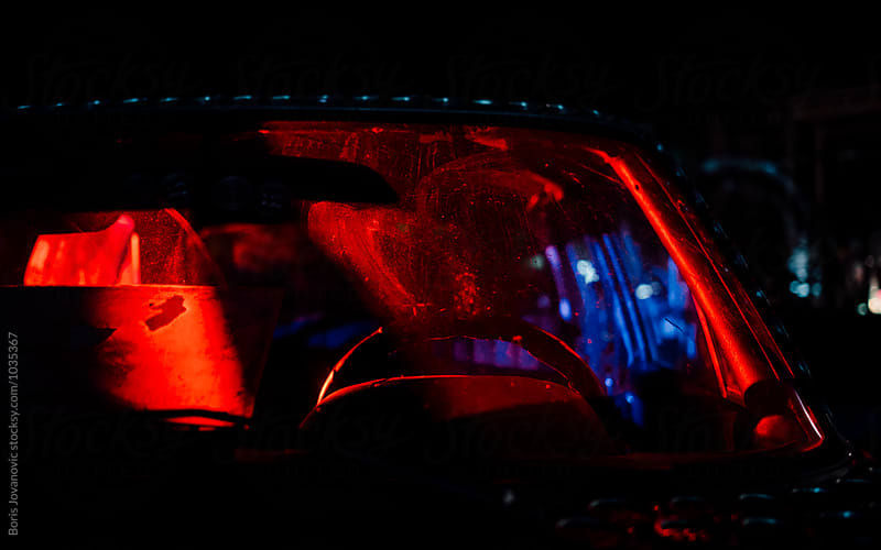 Front part of the car lit with red and blue light
