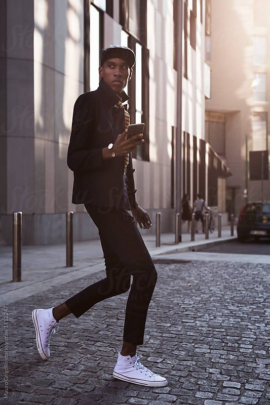 Stylish African American Businessman using mobile phone outdoor