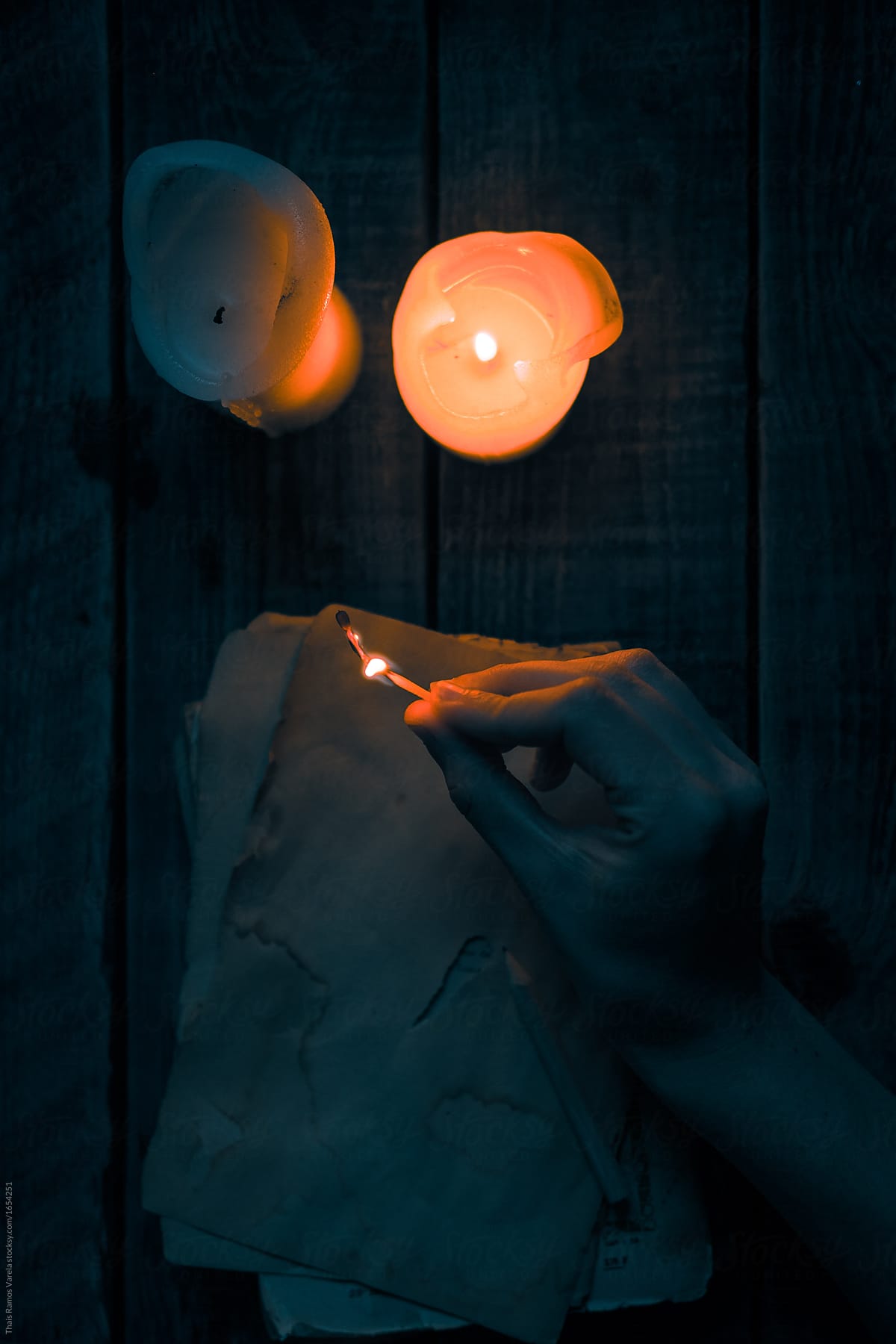 woman lights a match to light a candle