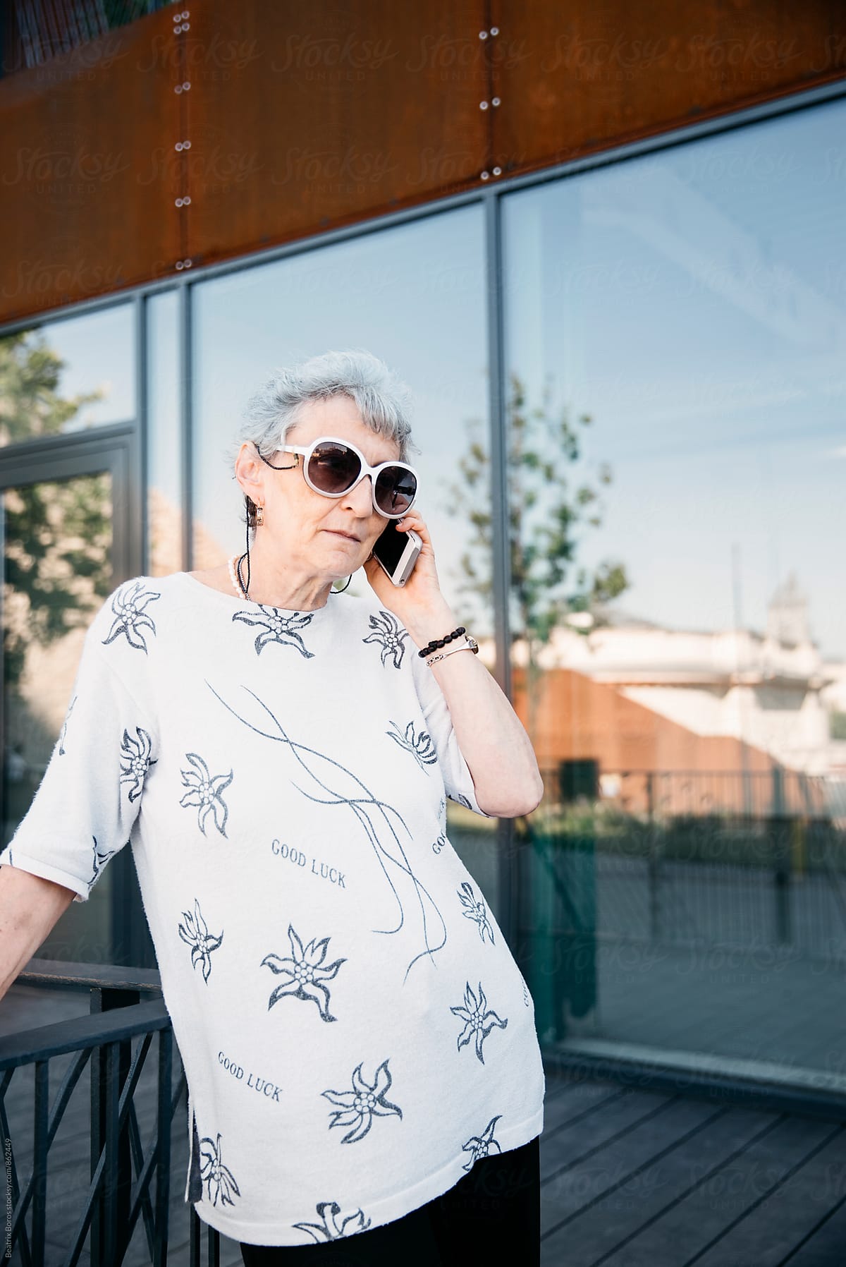 Senior Woman Talking On Her Cellphone Outdoors In Spring Time Del Colaborador De Stocksy 2579