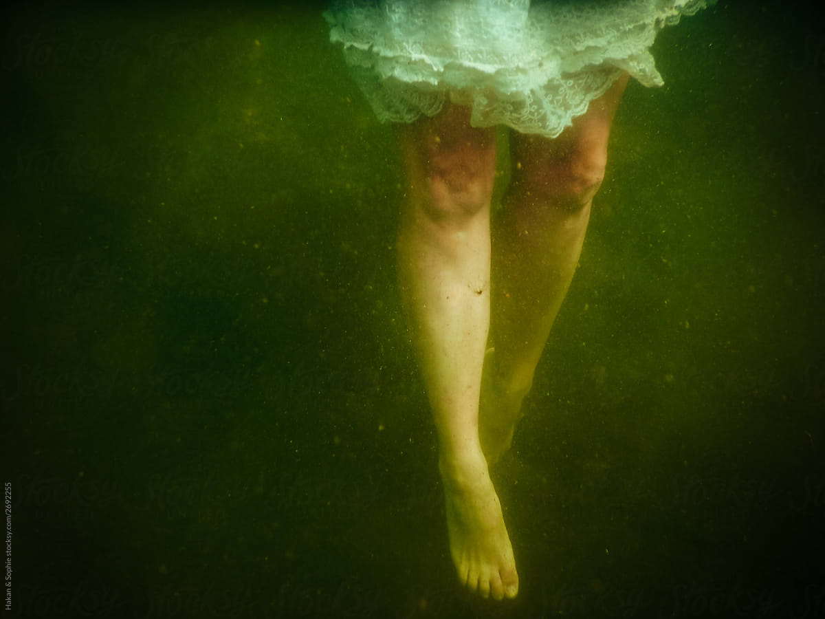 Woman\'s legs in murky waters