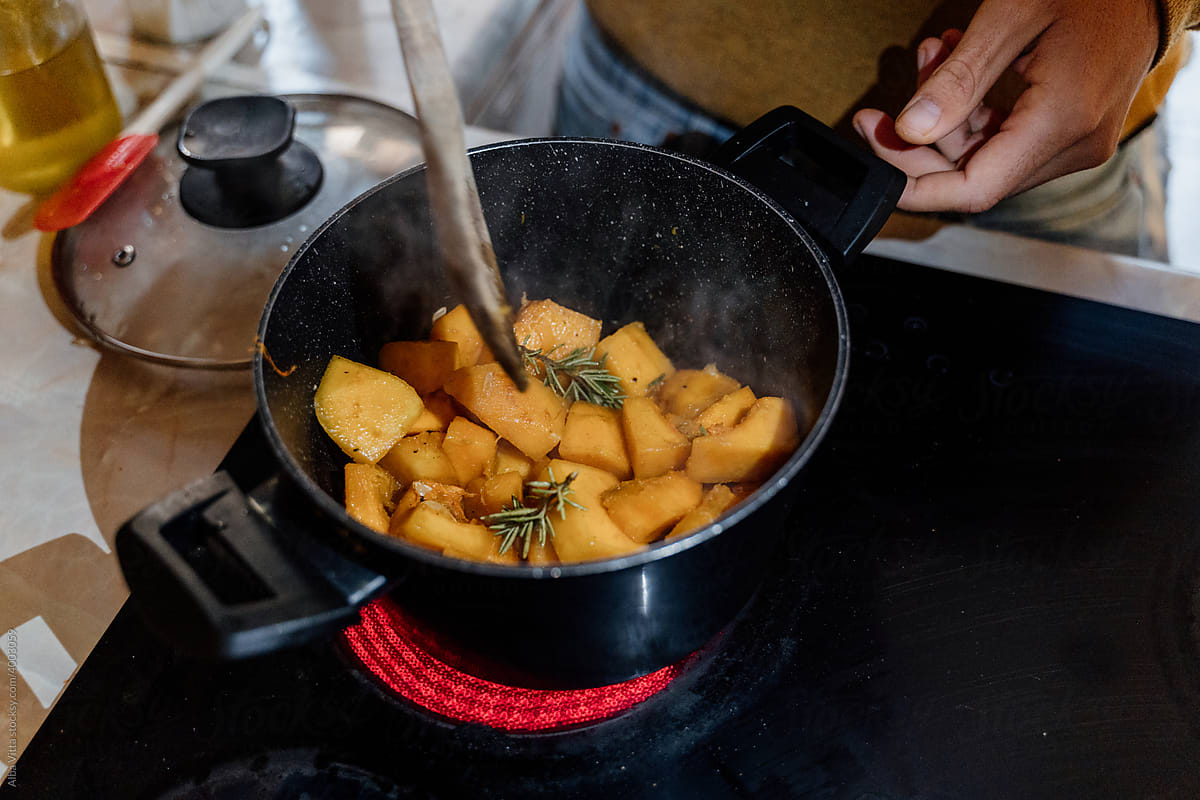 Cooking pot with potatoes on stove