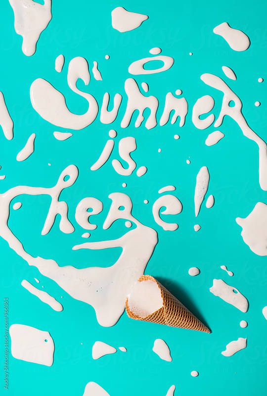 Summer is here text written with melted ice cream.