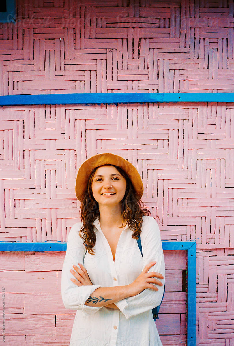 Portrait of cheerful woman on the background of pink wall