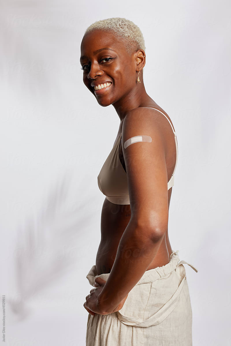 Happy woman with vaccine patch
