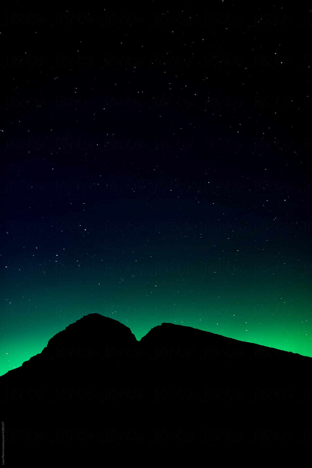 Northern lights behind mountains