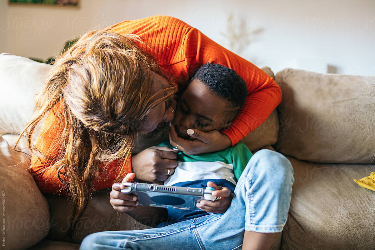 Little boy playing with a game console at home