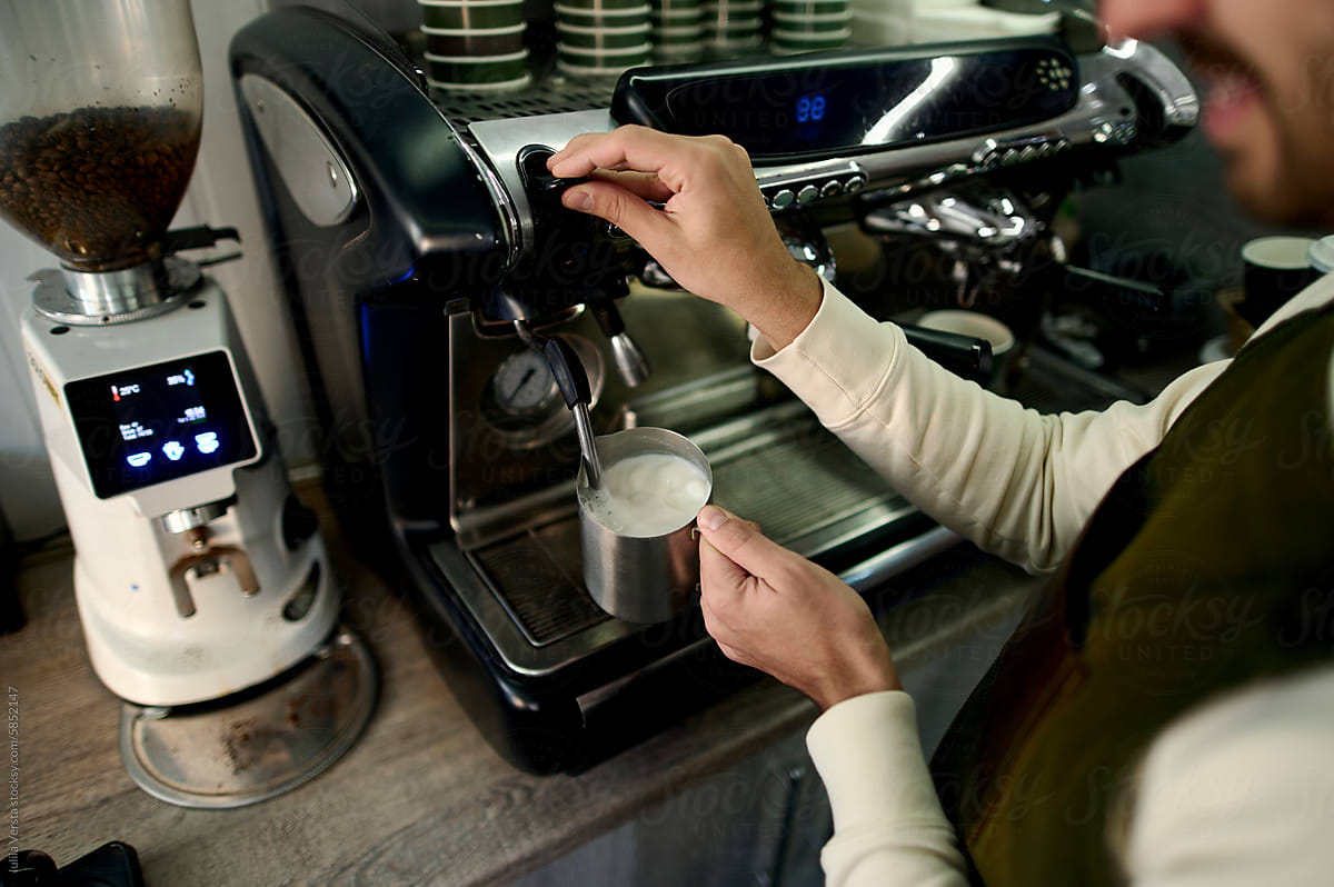 barista works on a professional coffee machine