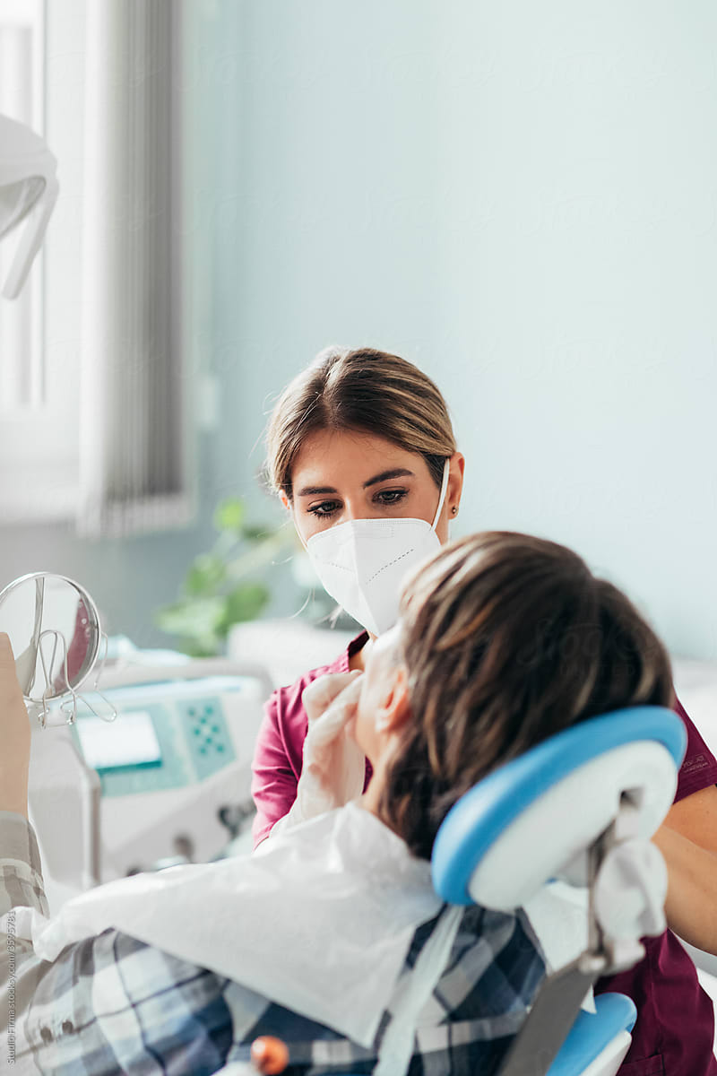 A Female Dentist Checking a Patient