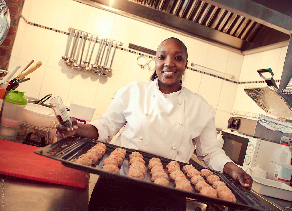 Female African cook baking in a restaurant