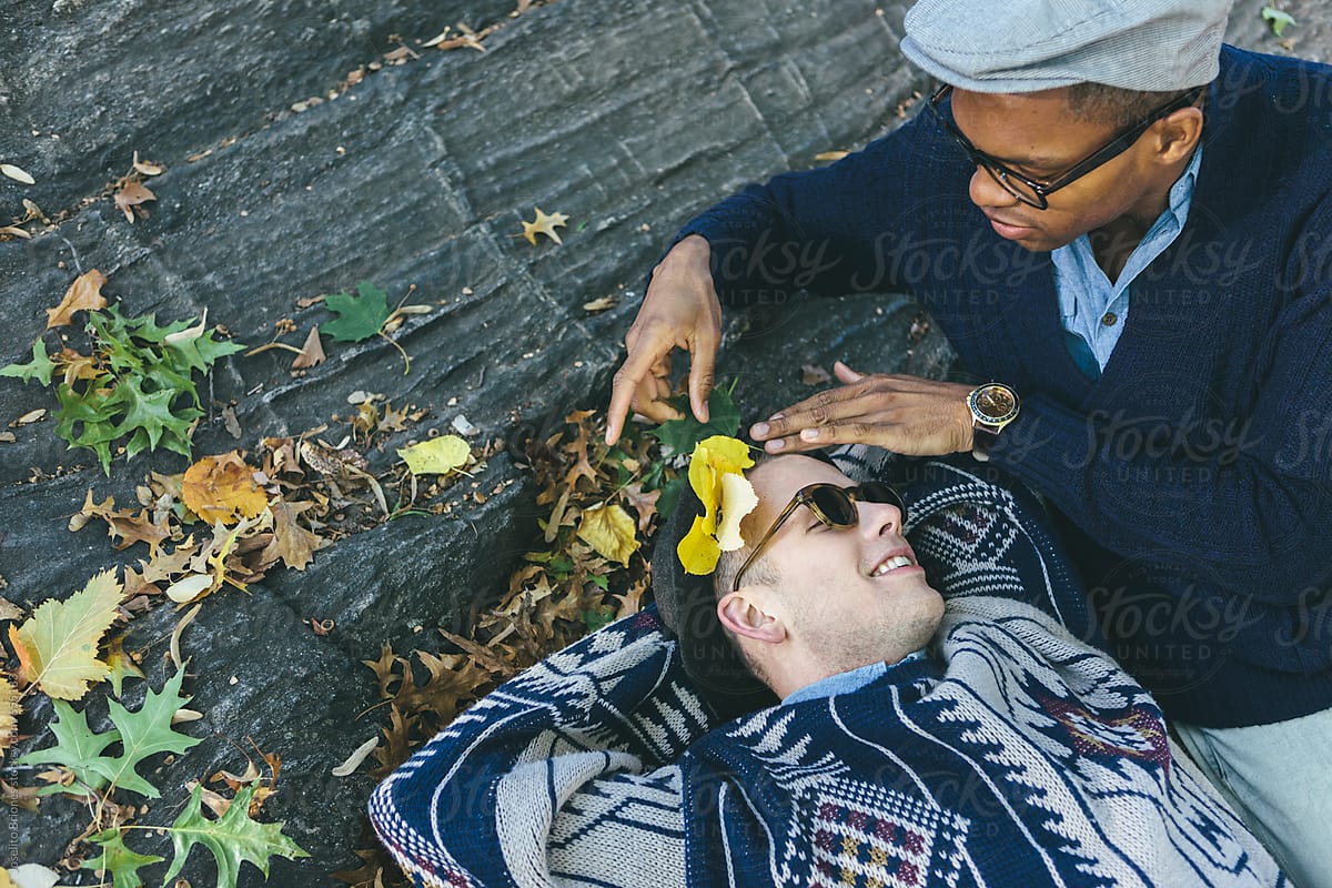 Young Gay Couple Having Romantic And Fun Intimate Moments Relaxing In New York Central Park By
