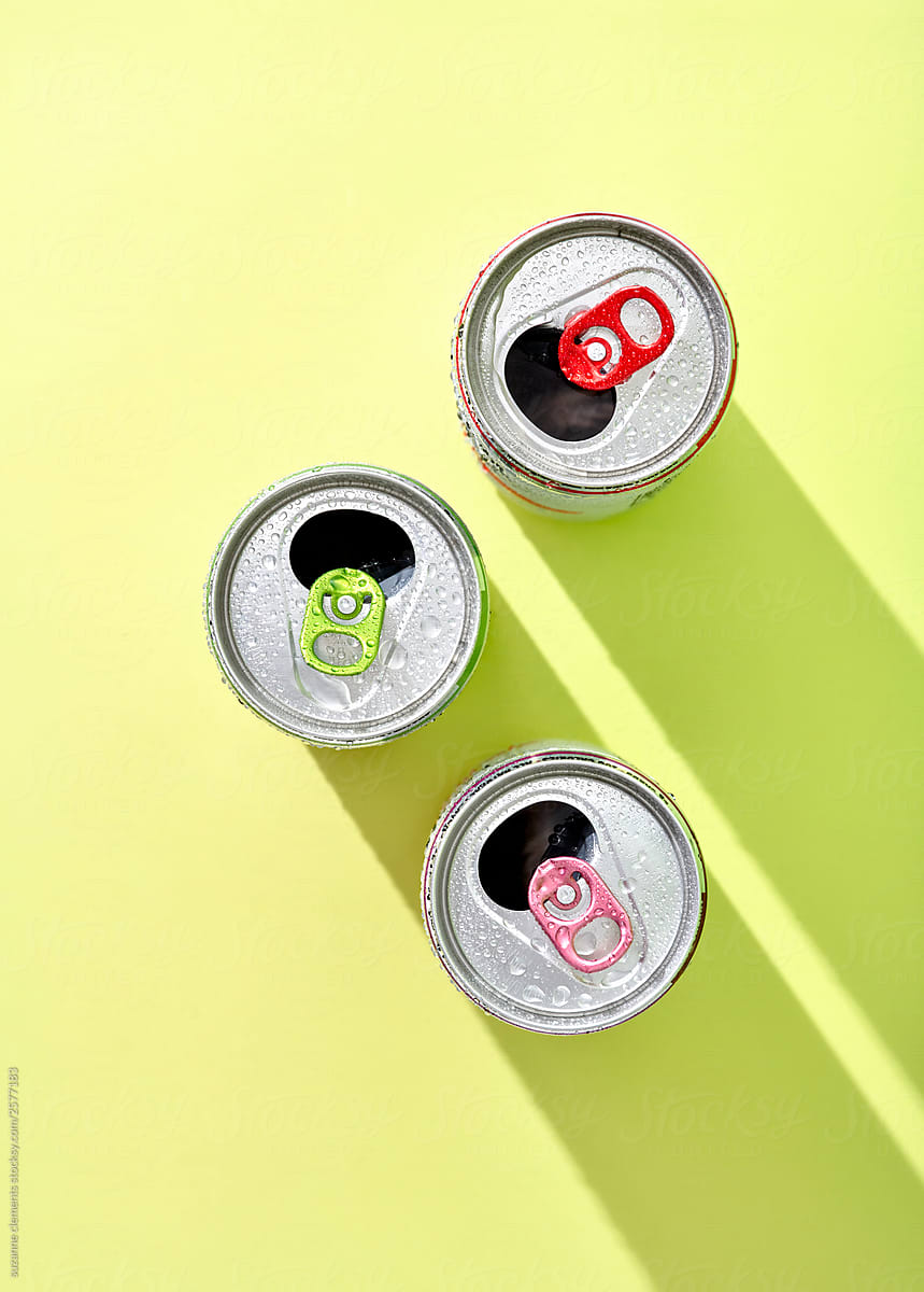 Colorful Drink Cans on Green