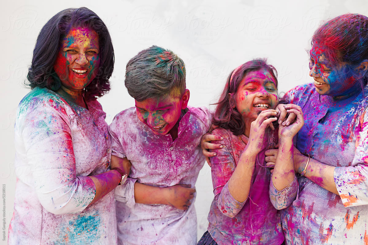 Family having fun together during holi the festival of colors
