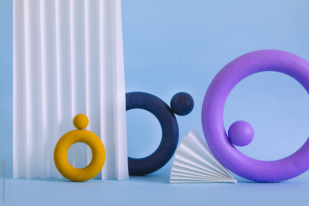Three colored objects together on paper background