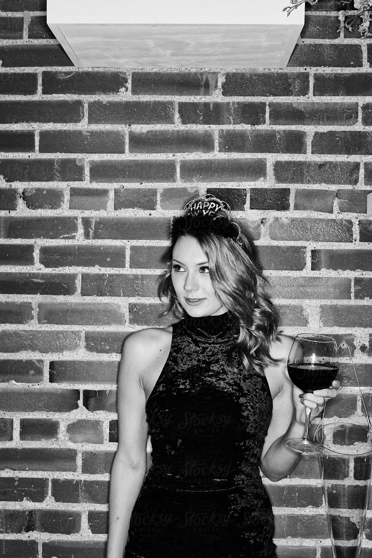 NYE: Woman Stands At Party With Wine Glass