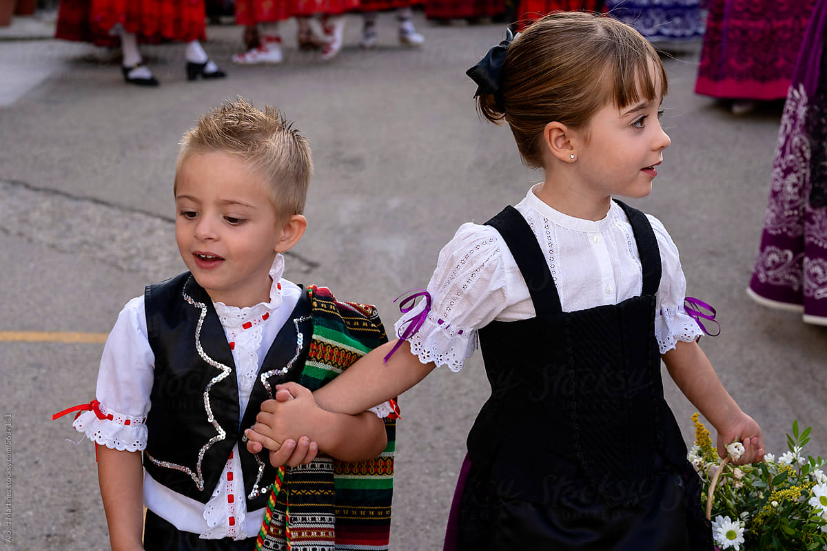 Happy cute brother and sister in traditional dresses