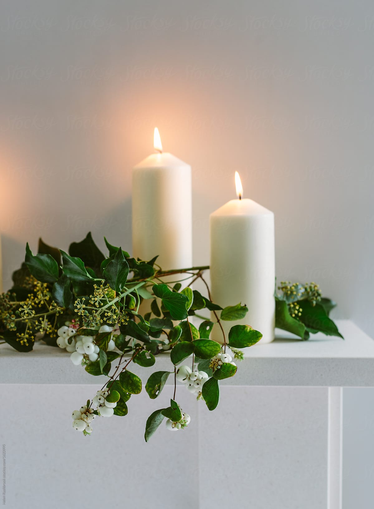 Ivy and pillar candles on a mantlepiece