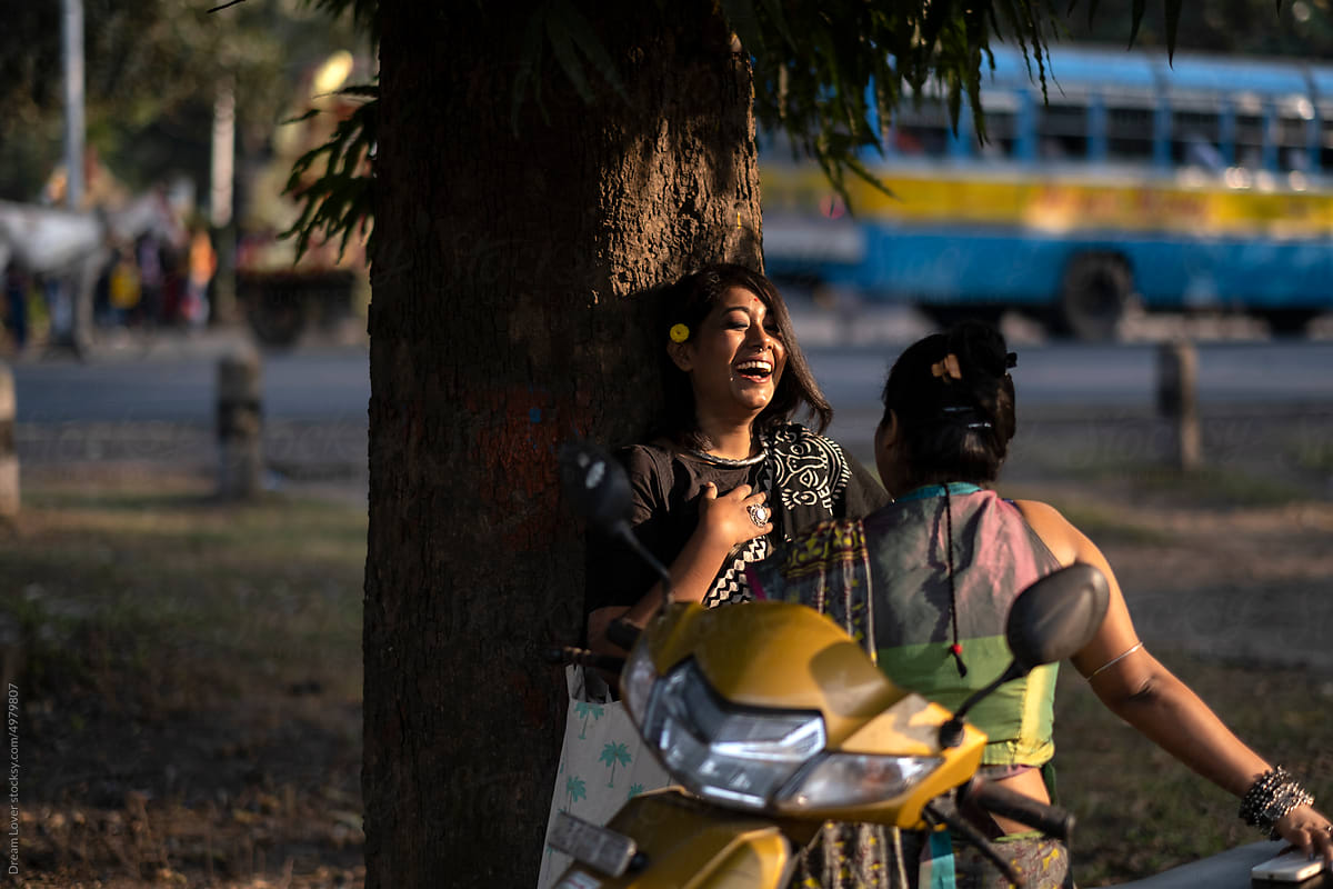 Indian woman wearing traditional  sari dress interacting at outdoors