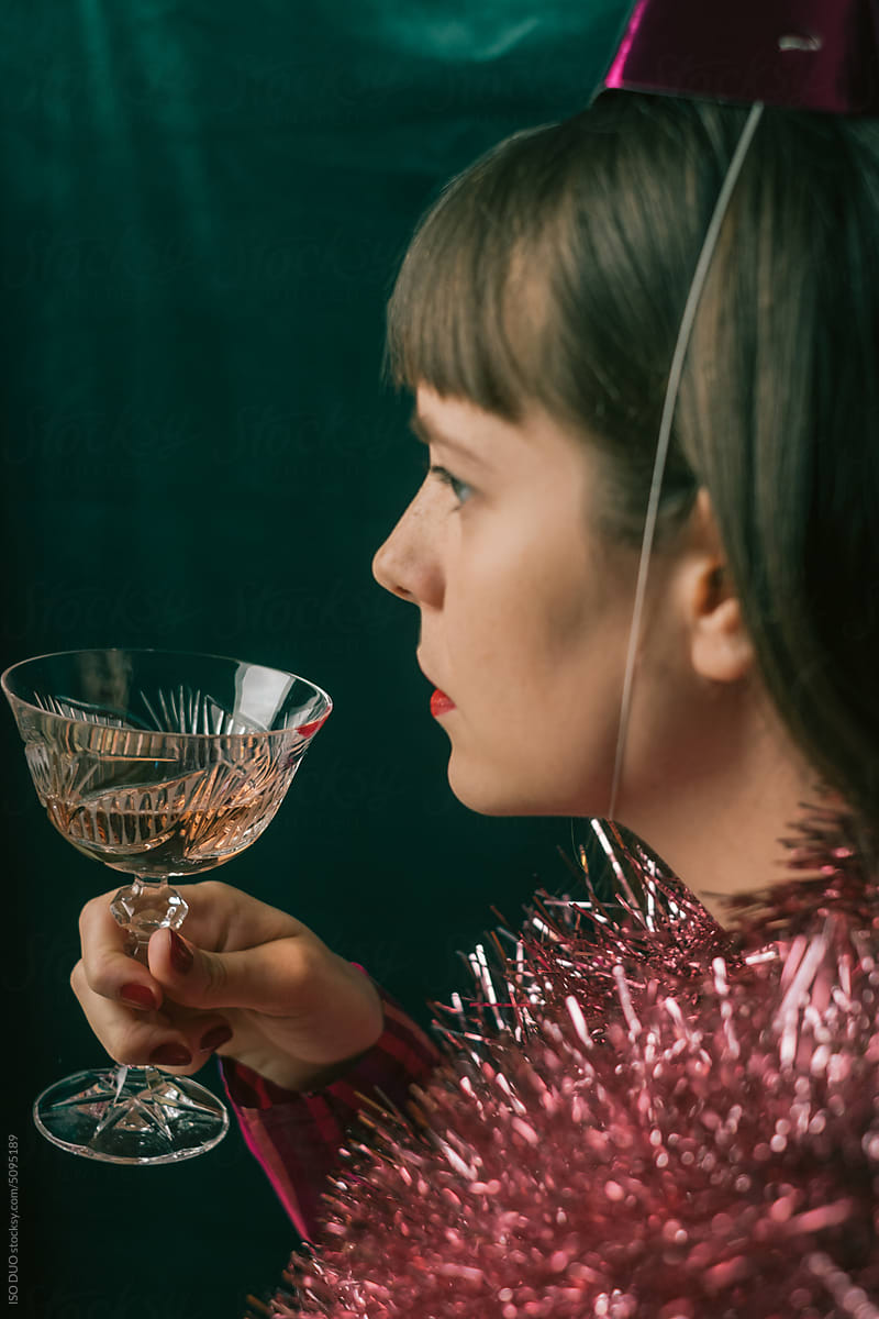 A woman holding a glass of Rose wine