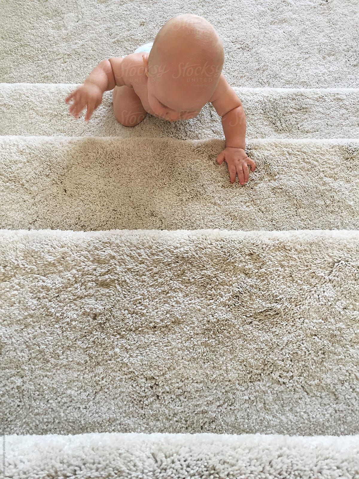 Cute Baby Climbing White Carpeted Stairs