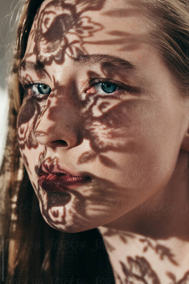 Closeup Portrait Of Amazing Girl With Floral Shadows On Her Face By Stocksy Contributor 9997