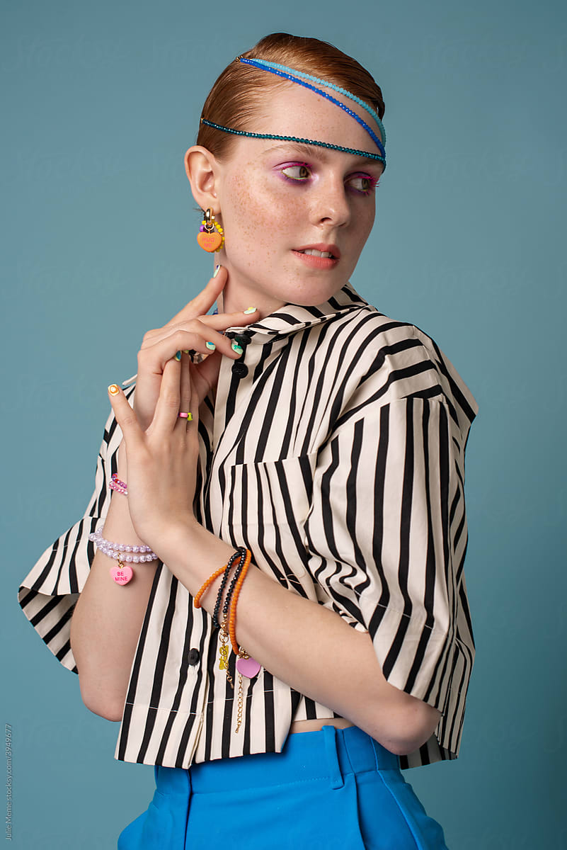 Portrait of a girl in a striped shirt and bright outfit