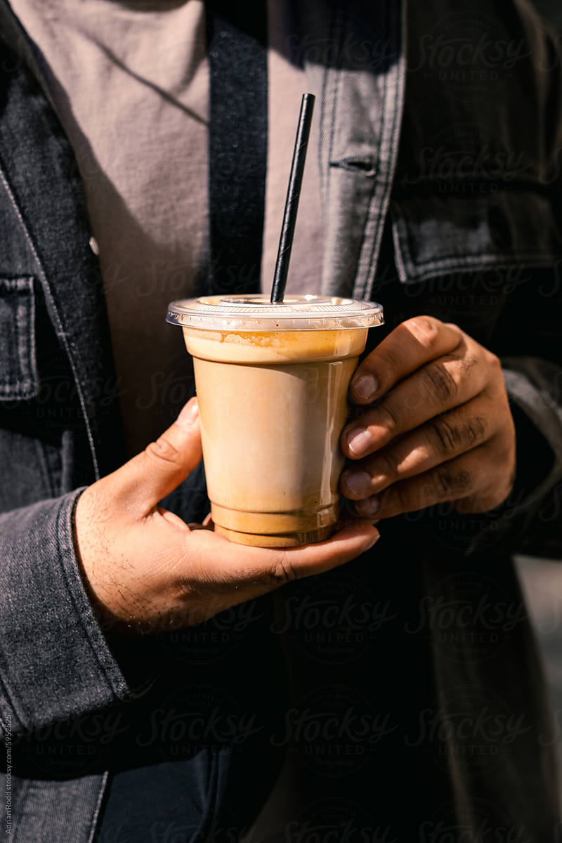 A person holds a freshly brewed ice latte