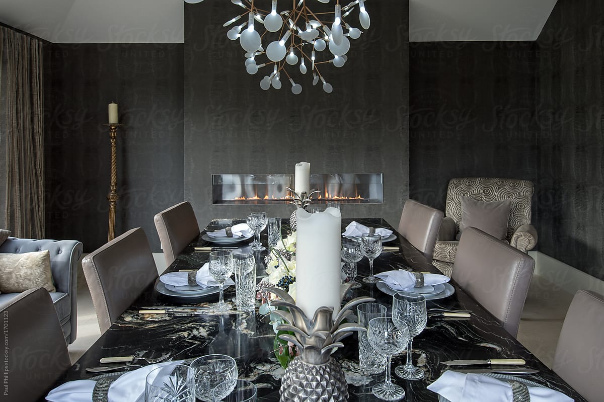 Large Black Granite Dining Table Set For A Meal. by Paul Phillips
