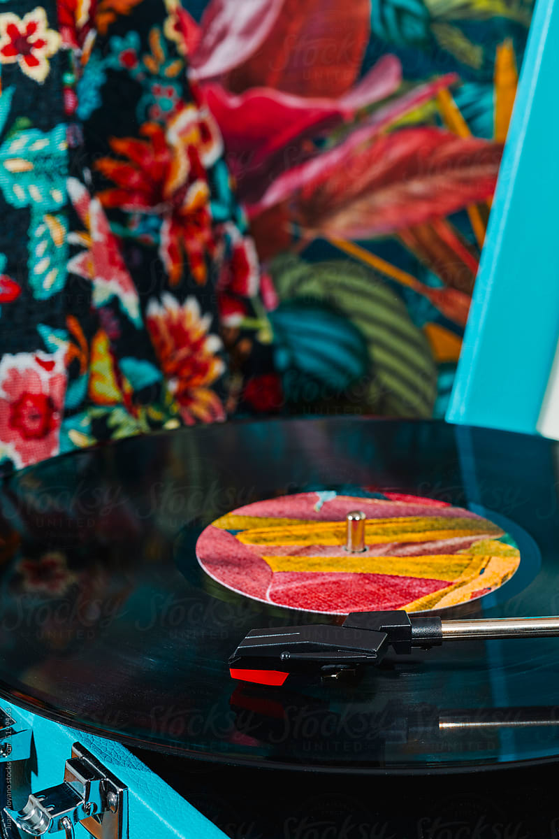 record being played in a retro blue turntable
