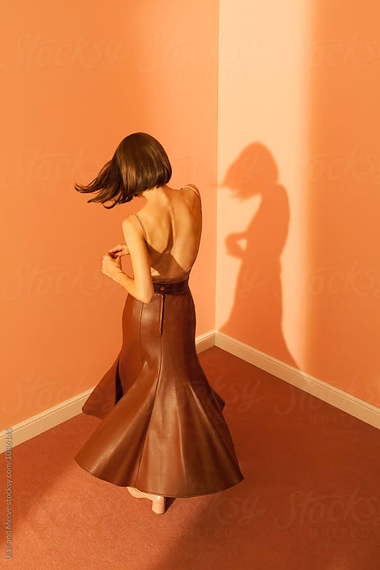 woman with long leather skirt dancing in the room