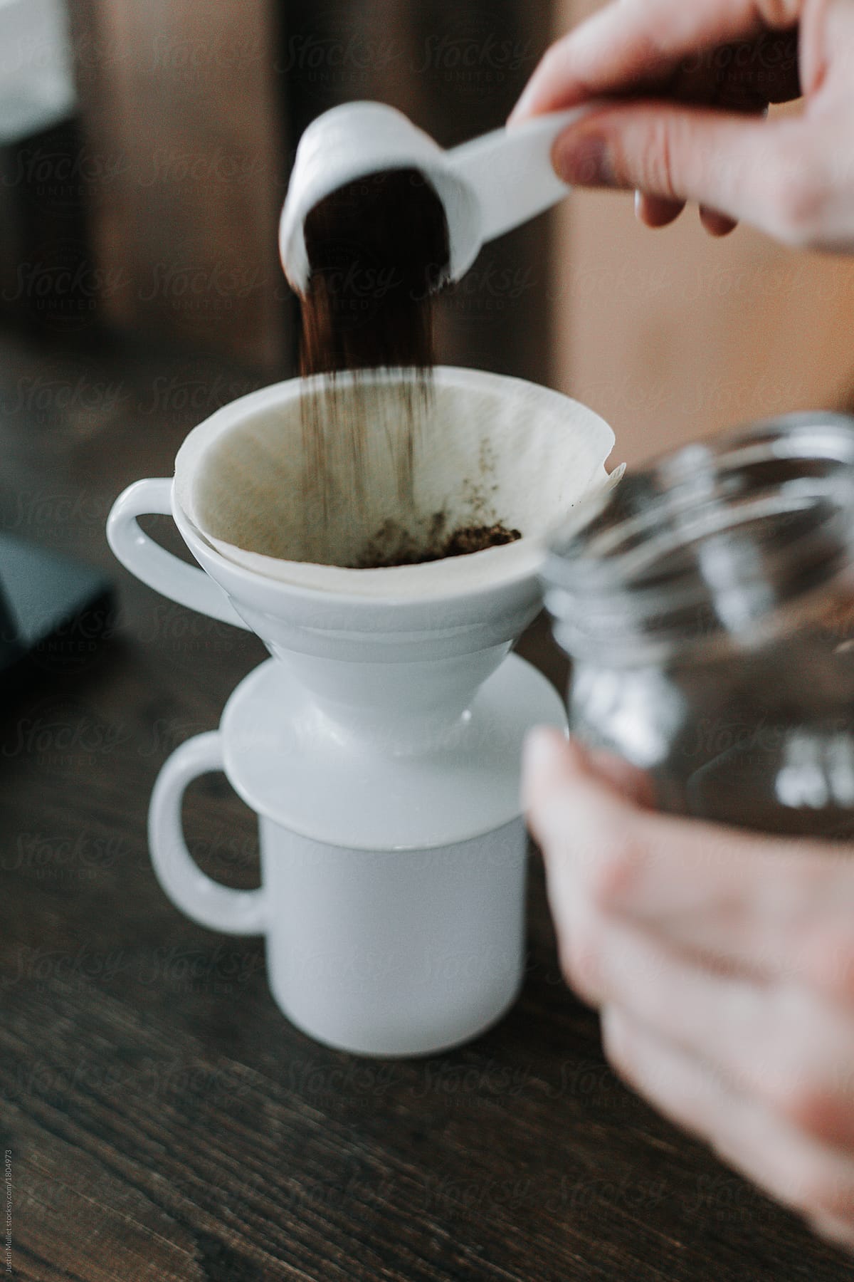 Pour ground coffee into a pour over cone and filter