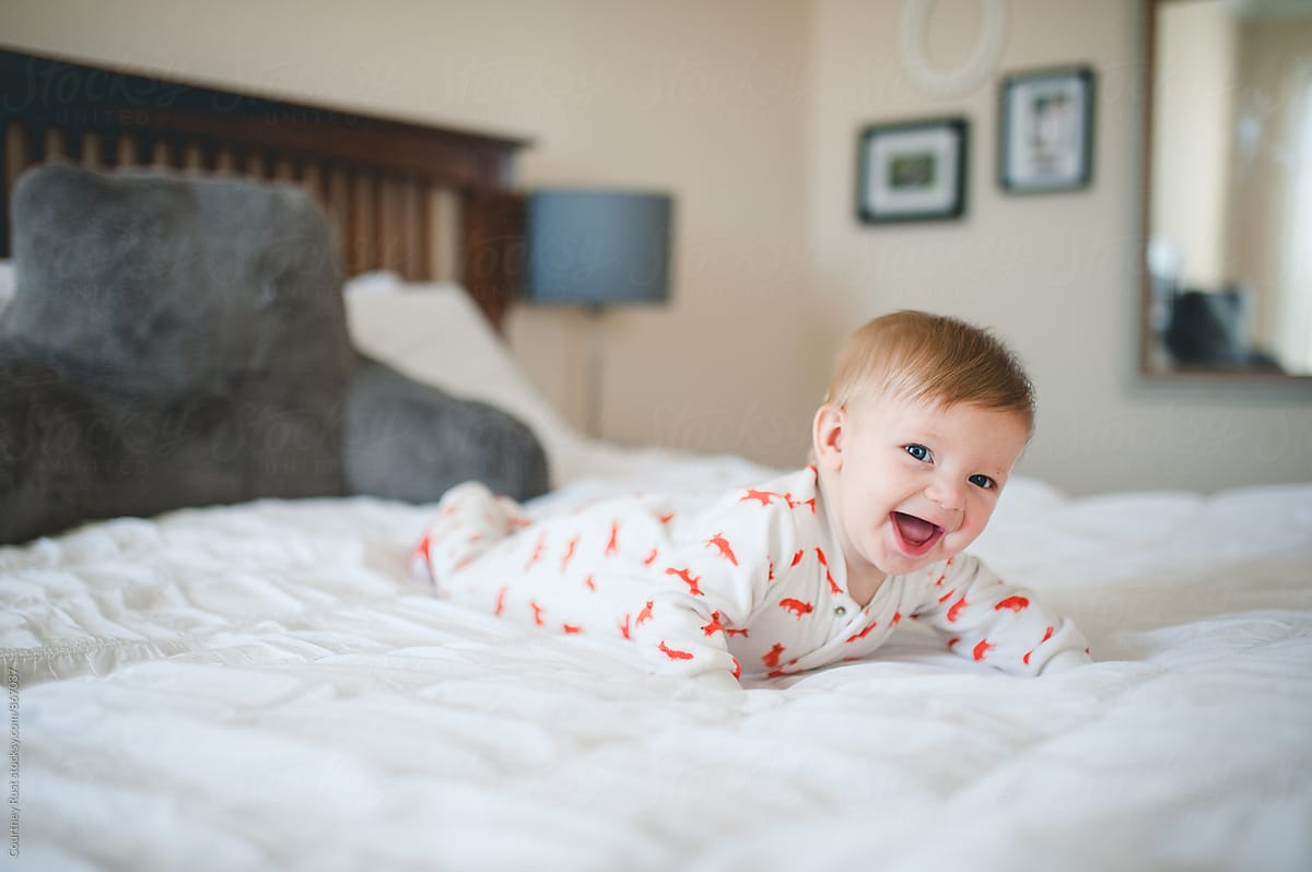 Happy baby on bed