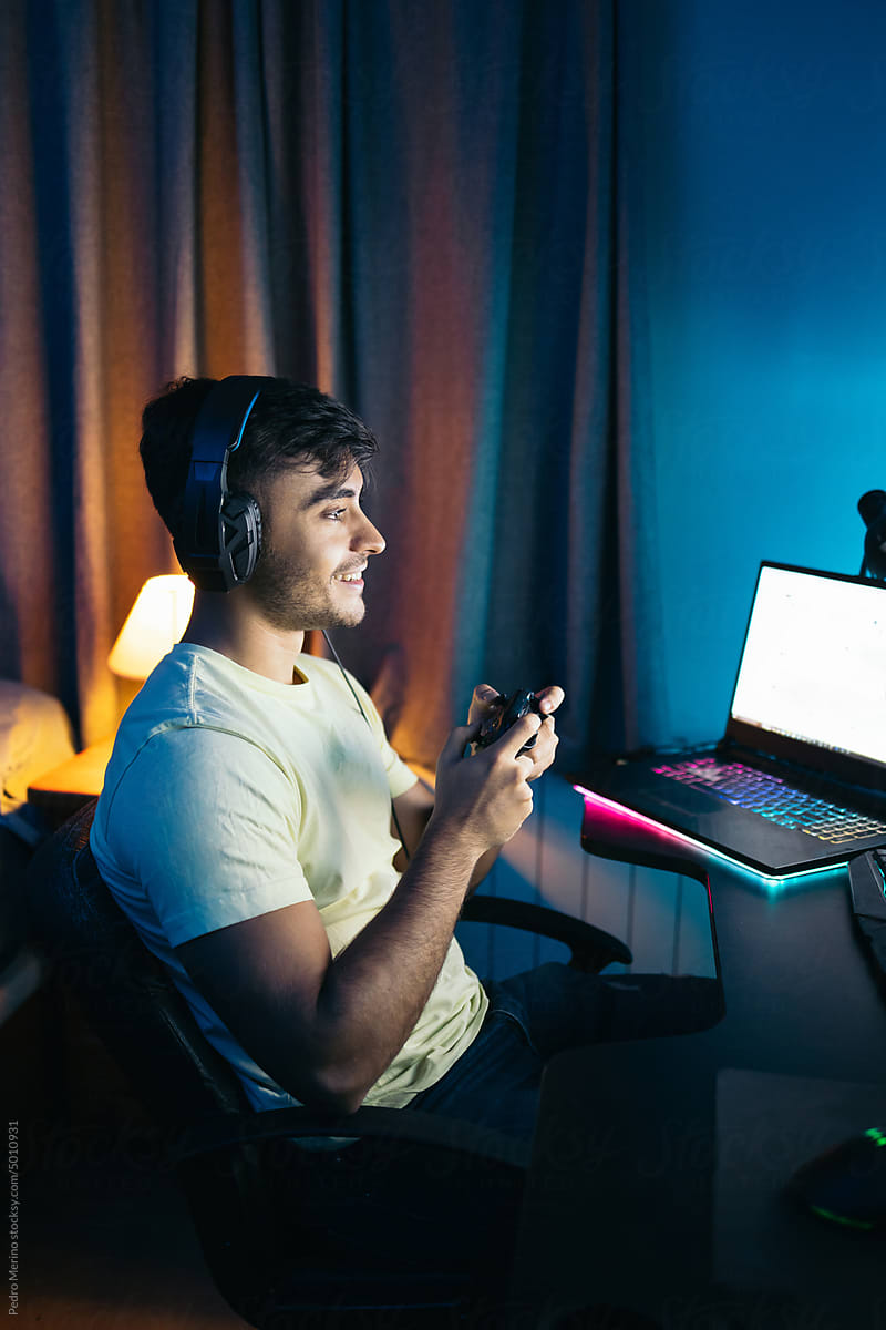 Young man playing video games online on pc