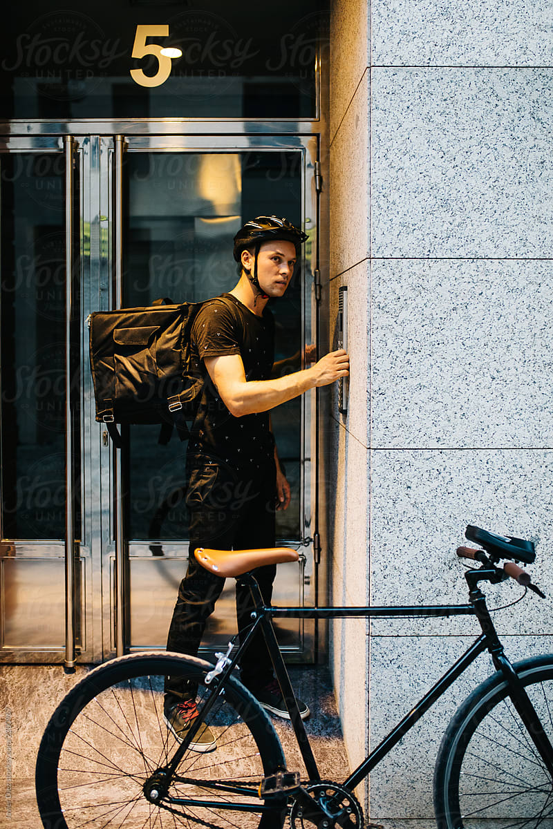Man with delivery backpack and bicycle