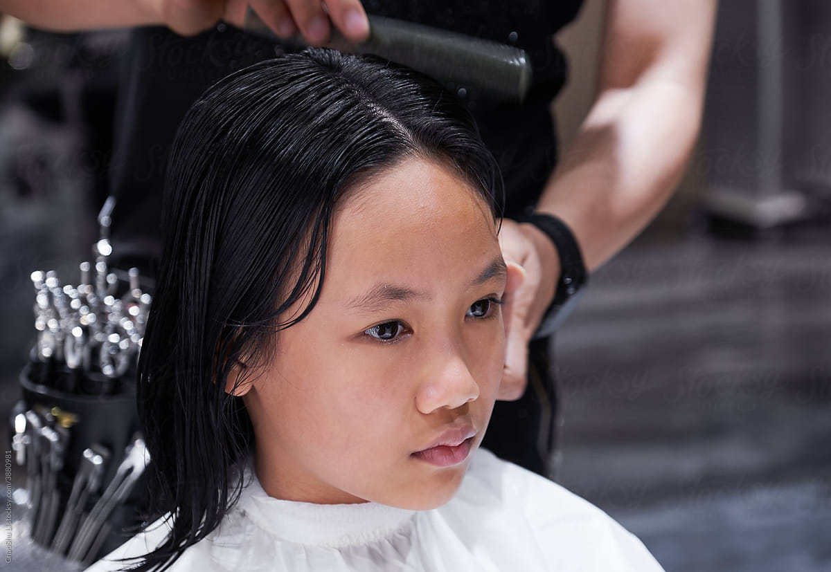Asian Chinese little girl getting a haircut