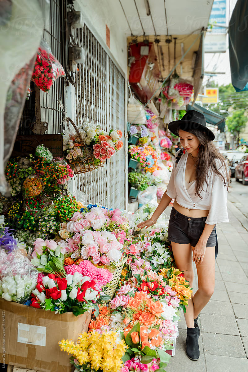 A woman looking at flowers at the florist