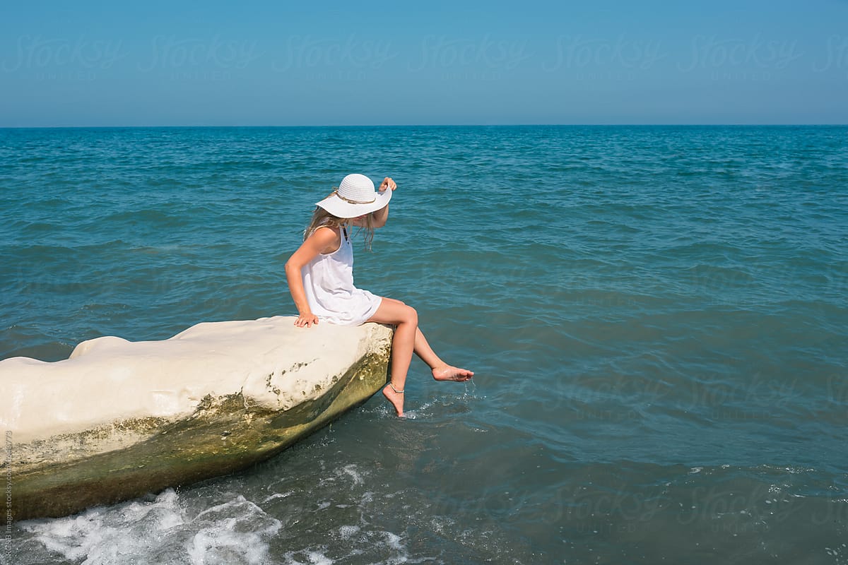 Beautiful woman cooling her feet in the sea water