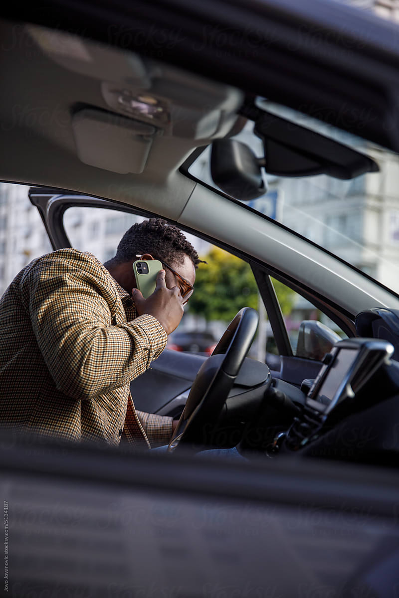 Freelancer on a phone call while getting into car