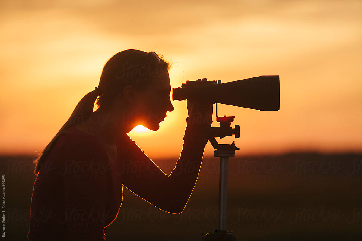 Woman With Binoculars Bird Watching on Marsh