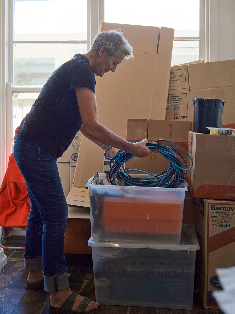 Older woman packing you up items during house move