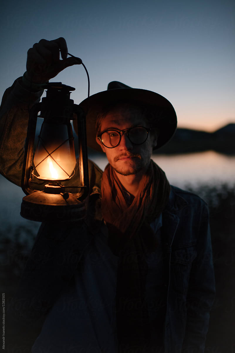 Man with lantern in evening