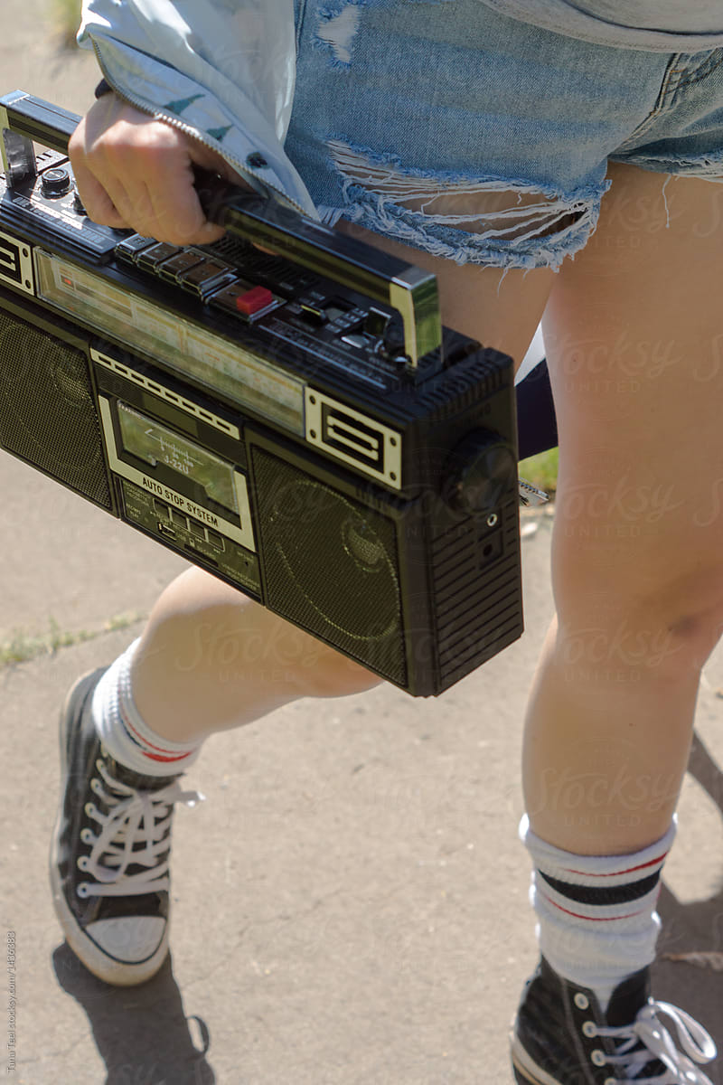 teenager carrying portable radio boom box