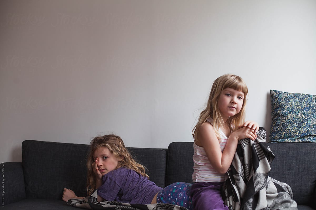 Sisters Cuddle On The Couch By Stocksy Contributor Cherish Bryck 
