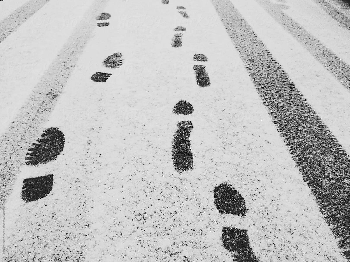 Footprints and car tracks on the city streets