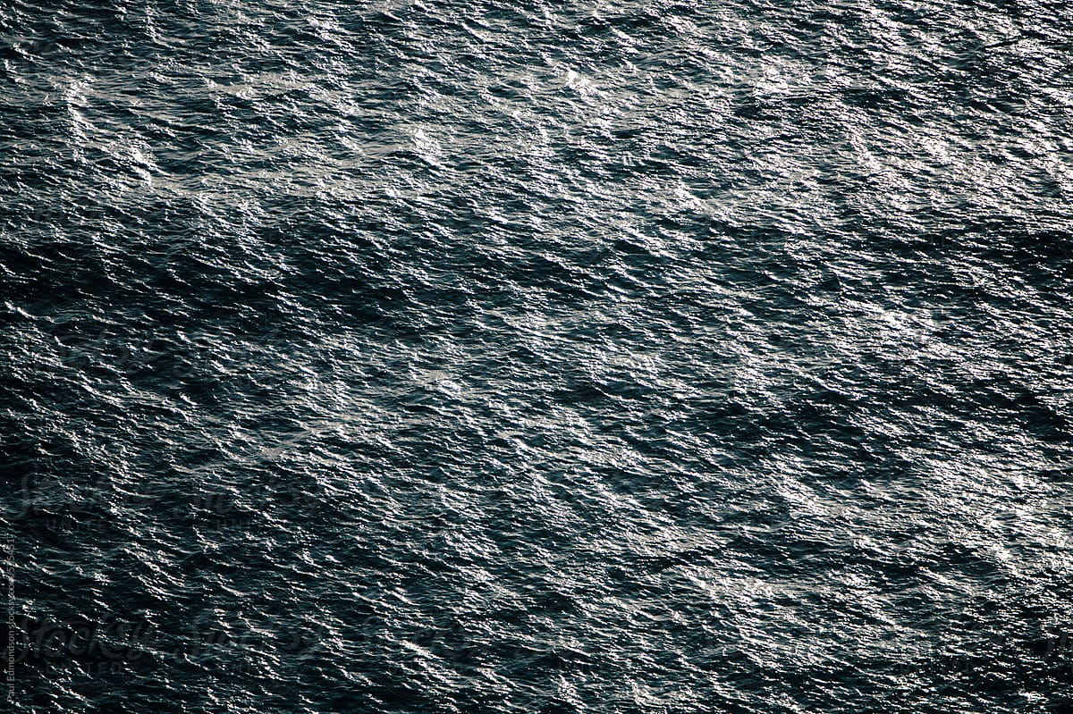 Detail of sunlight reflecting on ocean water and waves