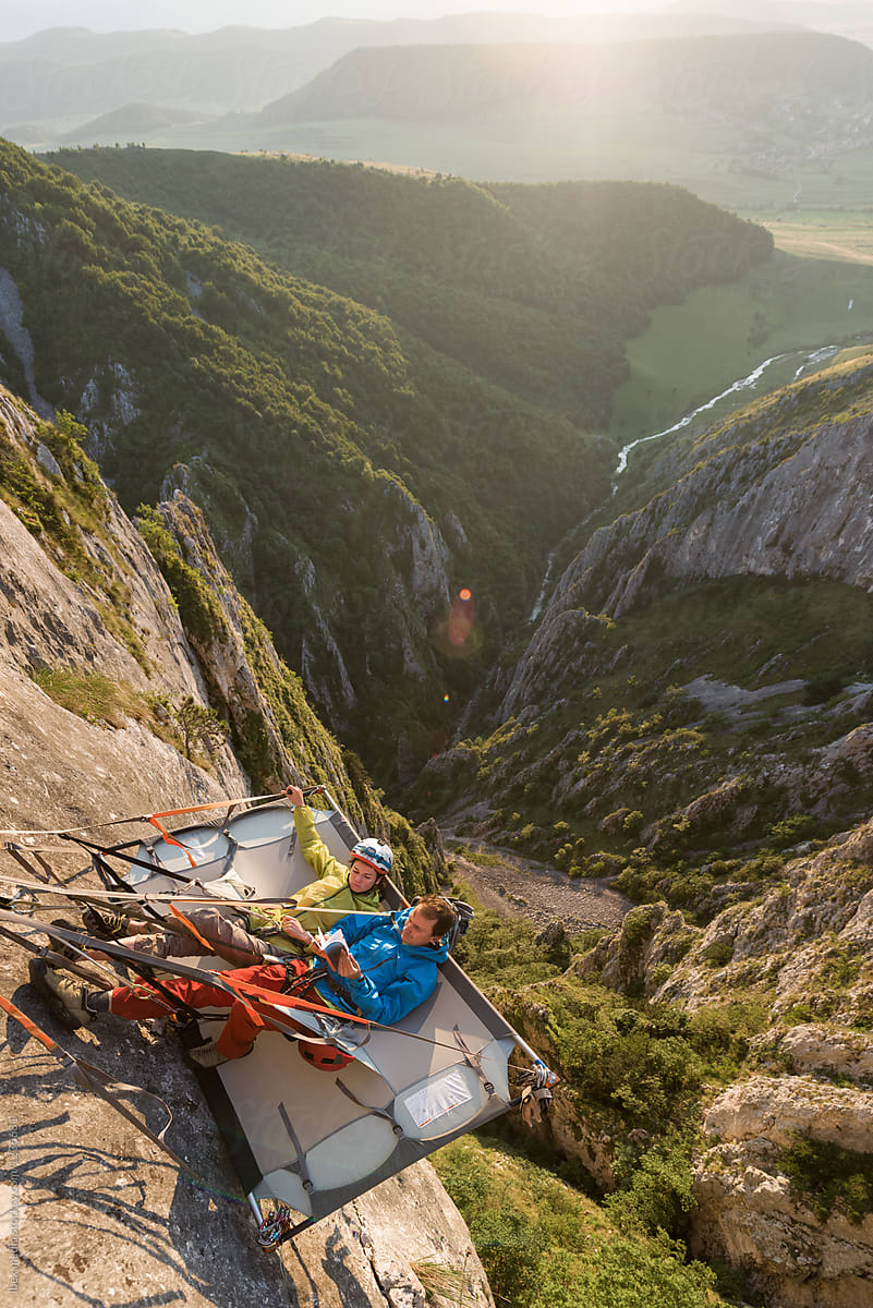Alpinist chilling on their portaledge high up on the rock face