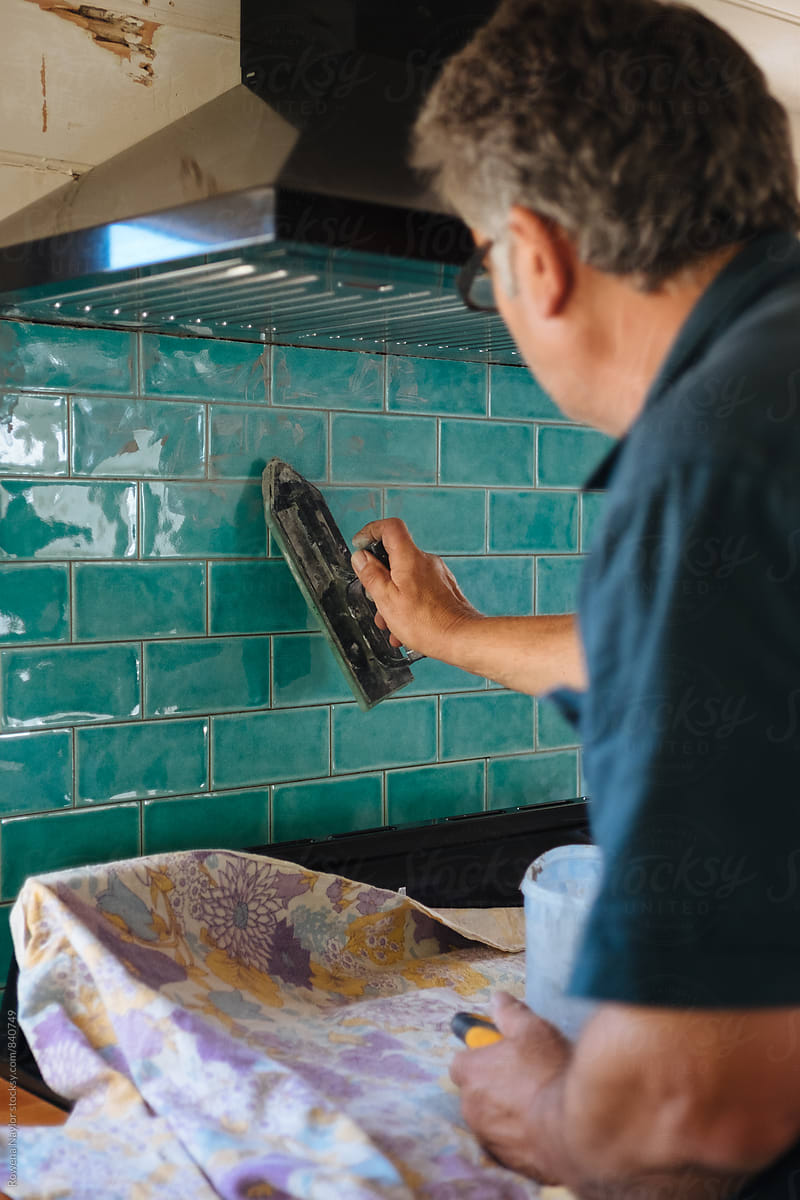 Tiler grouting kitchen tiles