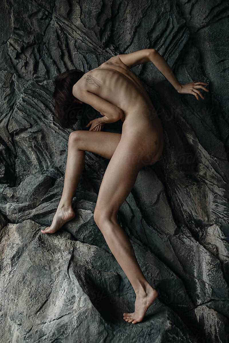 Anonymous Naked skinny woman staying on a rock