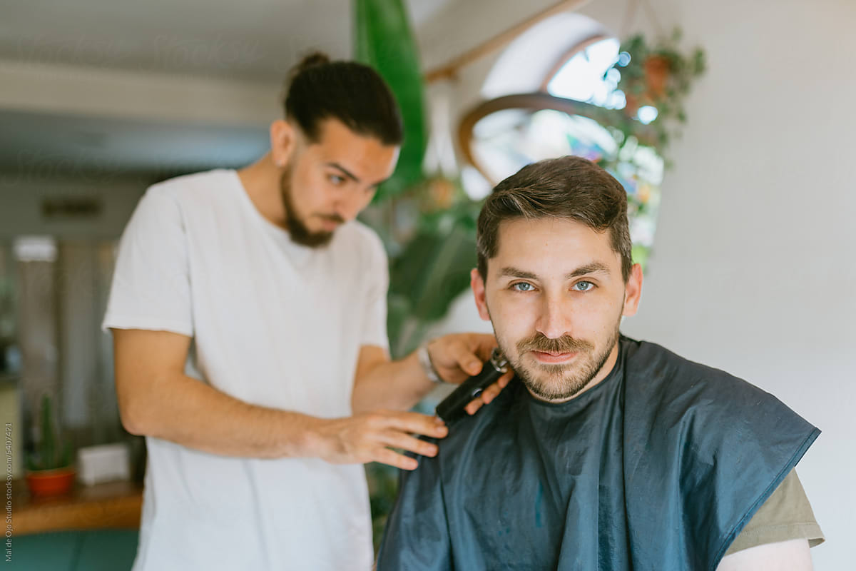 Camera-Aware Man Getting Home Haircut from a Friend
