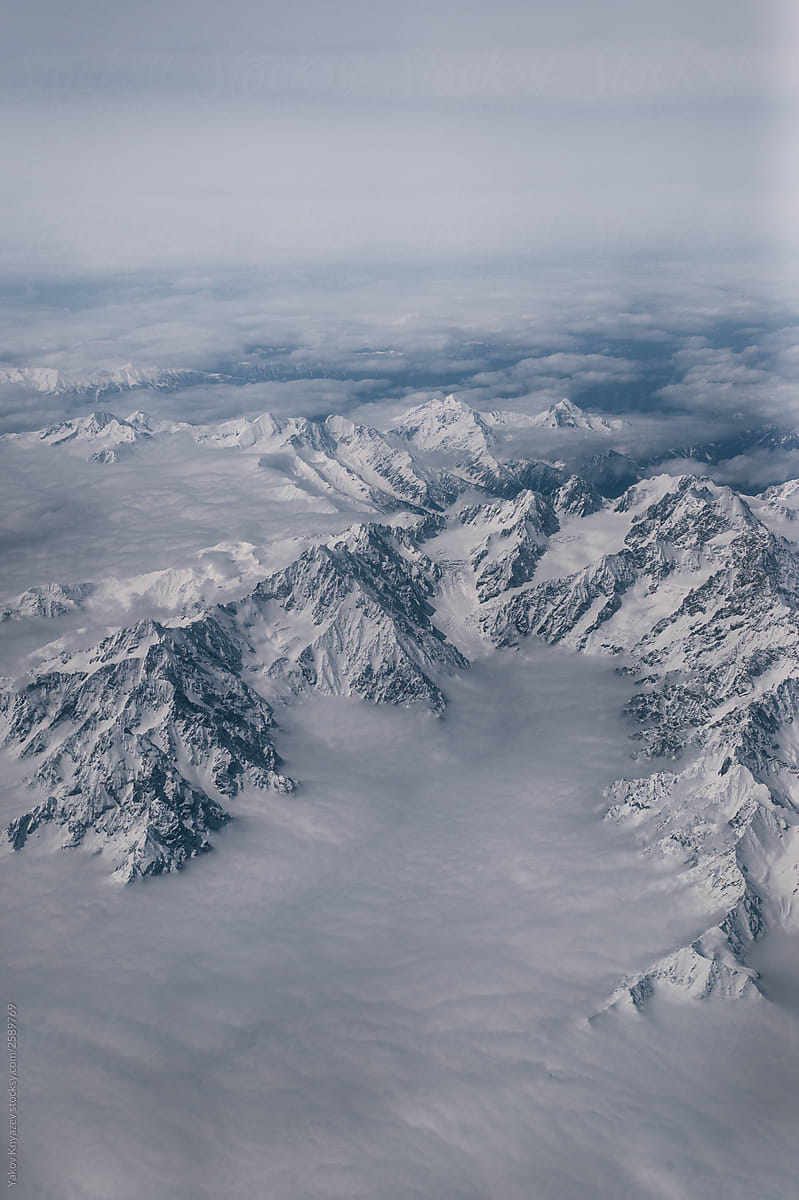 Snowy mountain summits shot from the airplane